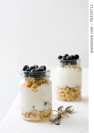Yogurt with fresh blueberries and cereals 76334711