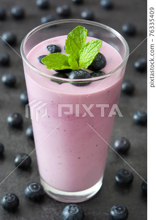 Fresh blueberry smoothie in glass Fresh blueberry smoothie in glass 76335409