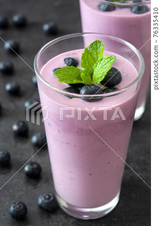 Fresh blueberry smoothie in glass Fresh blueberry smoothie in glass 76335410