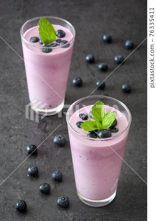 Fresh blueberry smoothie in glass Fresh blueberry smoothie in glass 76335411