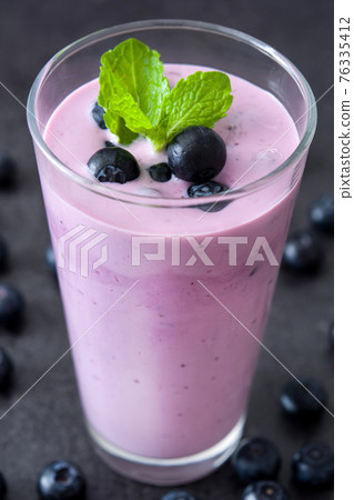 Fresh blueberry smoothie in glass Fresh blueberry smoothie in glass 76335412