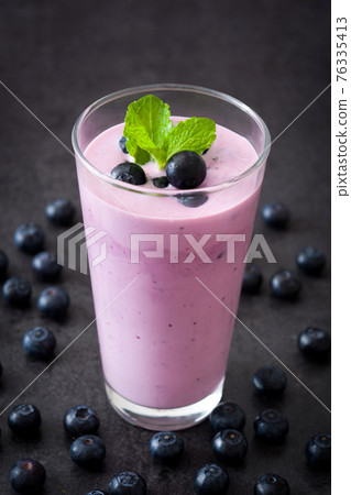Fresh blueberry smoothie in glass Fresh blueberry smoothie in glass 76335413