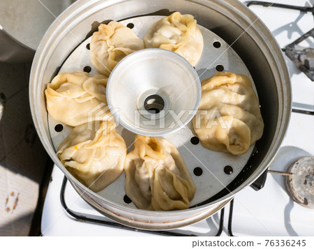 cooking of Manty dumpling in metal steamer pot 76336245