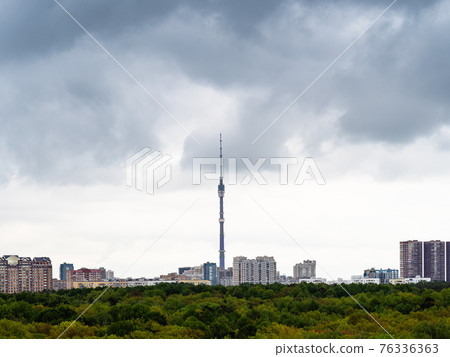 gray rainy clouds over city and park in spring 76336363