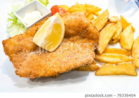 Chicken Milanese schnitzel with roasted potatoes 76336404