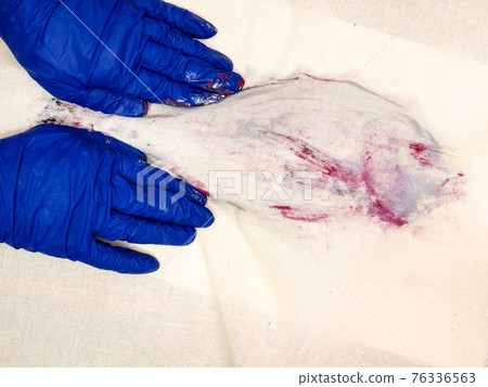 hands press colored fish with fabric 76336563