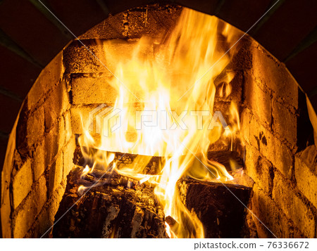 fire in stone fireplace 76336672