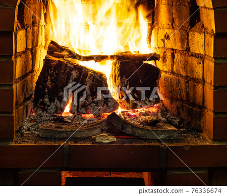 front view of burning firewood in heater 76336674