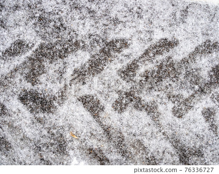 frozen tractor tire imprint on ice-covered road frozen tractor tire imprint on ice-covered road 76336727
