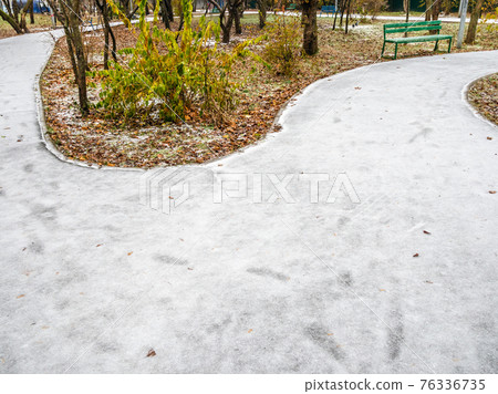ice-covered footpaths and frozen lawn in city park ice-covered footpaths and frozen lawn in city park 76336735