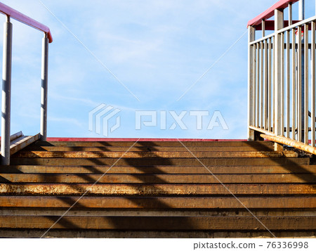 rusty steps of metal outdoor stairs to blue sky rusty steps of metal outdoor stairs to blue sky 76336998