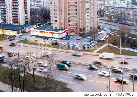 car traffic on street in spring evening twilight 76337002