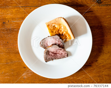 top view of sliced Roast Beef and piece of pudding 76337144