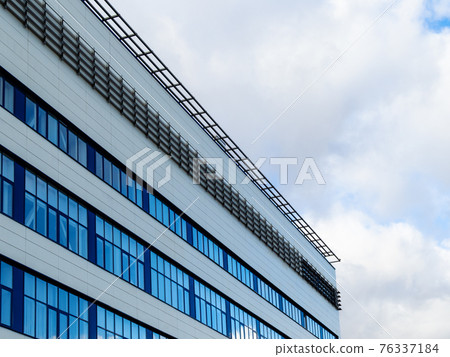 white cumuli clouds and modern factory building 76337184