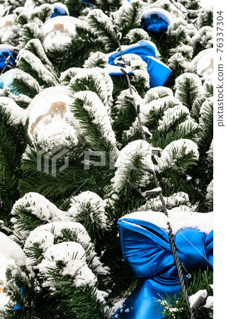 ornaments of snow-covered Christmas tree close up 76337304