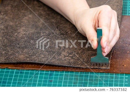 craftsman punches edge of leather item for handbag craftsman punches edge of leather item for handbag 76337382