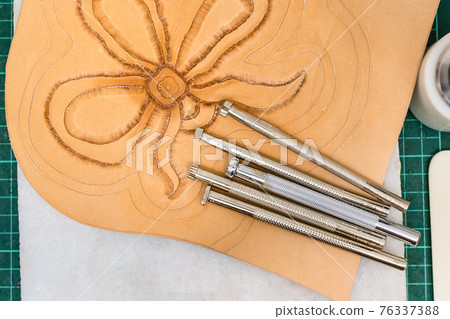various Stamping tools on partly carved leather various Stamping tools on partly carved leather 76337388