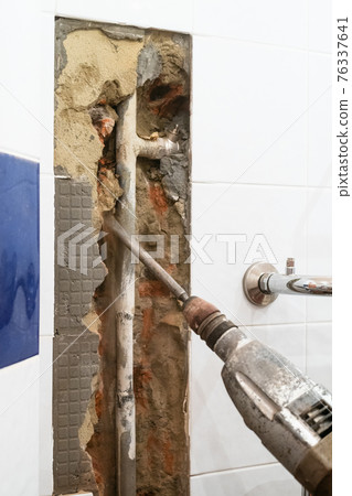 chiseling a brick wall to clean water pipe chiseling a brick wall to clean water pipe 76337641