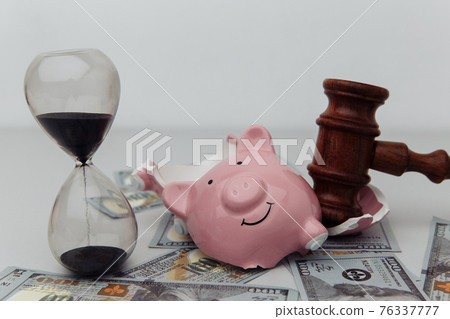 Broken piggy bank, hourglass and judge gavel. Bankruptcy or crisis concept Broken piggy bank, hourglass and judge gavel. Bankruptcy or crisis concept 76337777