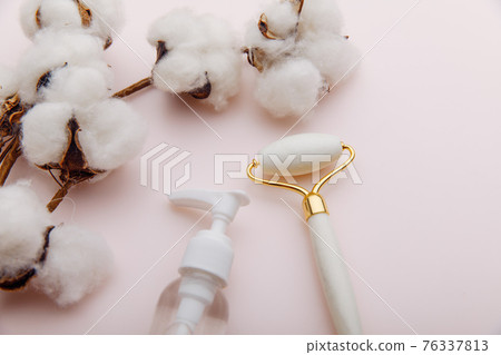 White stone roller with bottle of oil. Facial skin care at home, anti-aging and lifting therapy White stone roller with bottle of oil. Facial skin care at home, anti-aging and lifting therapy 76337813