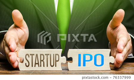 Man connects puzzles with words Startup and IPO. Listing entry of a business to stock exchange using initial public offering. Stocks market launch. Transformation of a private company into a public. Man connects puzzles with words Startup and IPO. Listing entry of a business to stock exchange using initial public offering. Stocks market launch. Transformation of a private company into a public. 76337999
