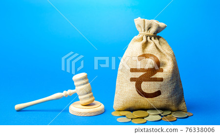 Ukrainian hryvnia money bag and judge's gavel. Litigation, dispute resolution, conflict of interest settlement. Protection rights. Justice. Lawyer services. Awarding moral financial compensation. 76338006
