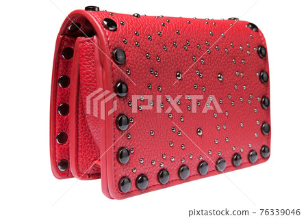 small red women's handbag, decorated with rhinestones and metal rivets, on a white background small red women's handbag, decorated with rhinestones and metal rivets, on a white background 76339046