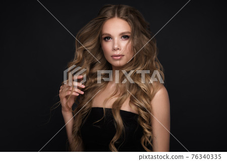 Beautiful blond girl with a perfectly curls hair, and classic make-up. Beauty face and hair. Beautiful blond girl with a perfectly curls hair, and classic make-up. Beauty face and hair. 76340335