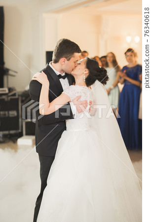 Beautiful caucasian wedding couple just married and dancing their first dance 76340618