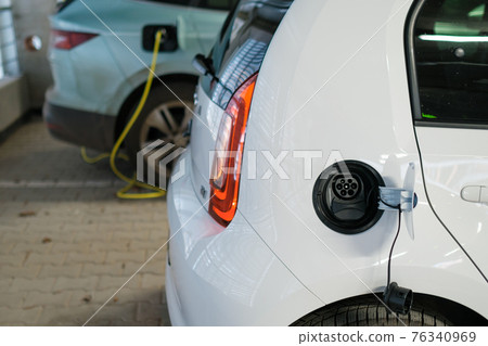 Electric cars charging at the charging station. Zero emission cars. Electric cars charging at the charging station. Zero emission cars. 76340969