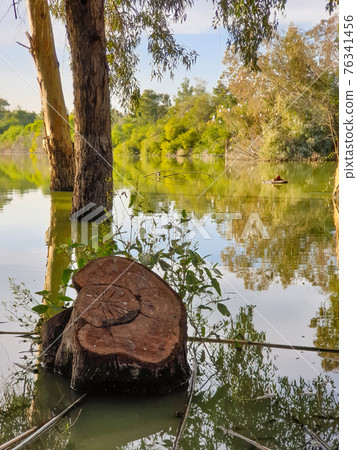 Athalassa Lake, Cyprus with beautifully lit water, and trees on a beautiful sunny afternoon Athalassa Lake, Cyprus with beautifully lit water, and trees on a beautiful sunny afternoon 76341456