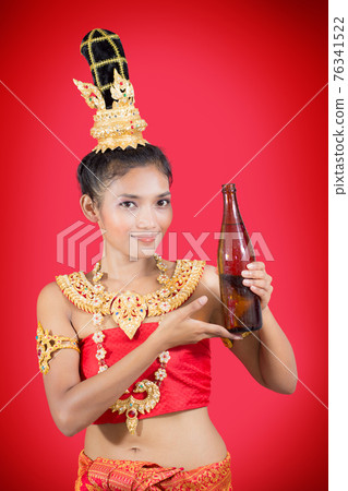Thai woman holding a bottle of drink 76341522