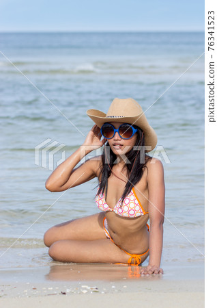 Attractive woman on the sea beach 76341523