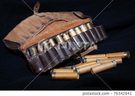 vintage retro brown leather hunting bandolier with cartridges on black 76342841