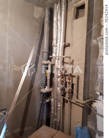 Layout of plastic plumbing pipes with water meters in a new studio apartment in a new building without repair Layout of plastic plumbing pipes with water meters in a new studio apartment in a new building without repair 76342914
