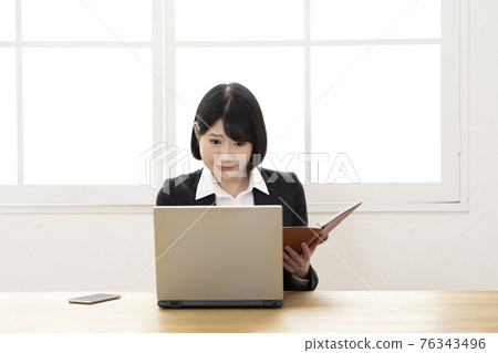 Business woman checking with laptop and business notebook Business woman checking with laptop and business notebook 76343496