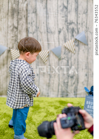 Image of a child taking a photo in the studio Image of a child taking a photo in the studio 76343552