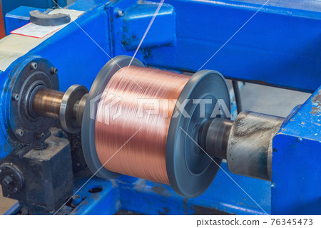 Metal wire spool spins. Metal wire spool spins. 76345473