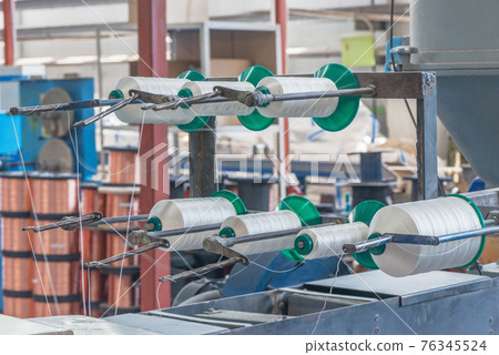 Spools of thread inside of the plant. Spools of thread inside of the plant. 76345524
