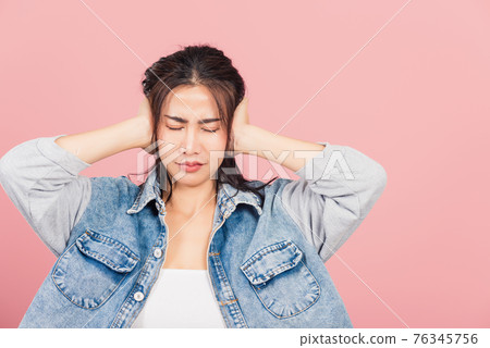 woman wear denim have closed ears with hand palms and close eyes 76345756