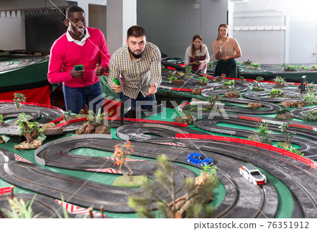 Men remote control race car models on the track Men remote control race car models on the track 76351912