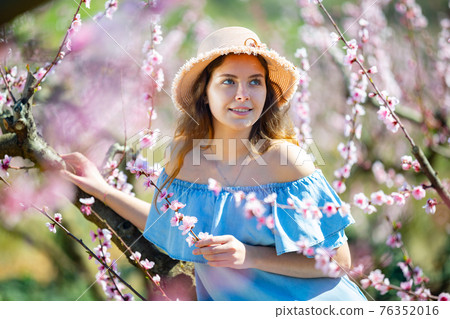 Girl in the spring garden peach in blue dress and hat Girl in the spring garden peach in blue dress and hat 76352016