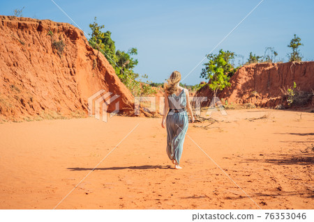Woman tourist in red canyon, resumption of tourism concept Woman tourist in red canyon, resumption of tourism concept 76353046