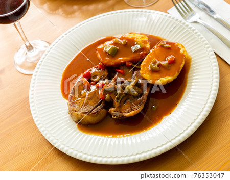 Tasty lamb meat baked and served with sauce and potatoes 76353047