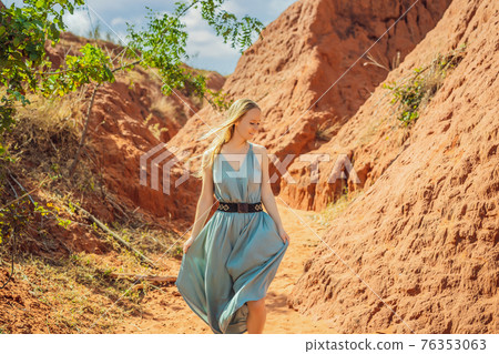 Woman tourist in red canyon, resumption of tourism concept 76353063