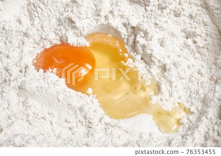 Fresh chicken egg, knife and wheat flour Fresh chicken egg, knife and wheat flour 76353455