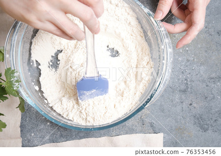 Flour is sieved with a metal sieve Flour is sieved with a metal sieve 76353456