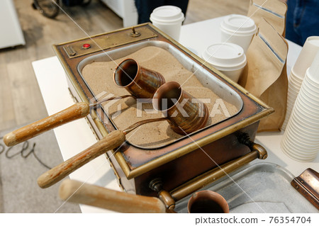 Oriental coffee or Turkish coffee. Coffee turk, hot sand. 76354704