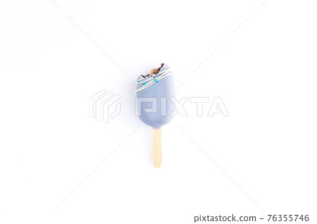 Isolated bitten blue cookie ice cream on a stick on white background Isolated bitten blue cookie ice cream on a stick on white background 76355746