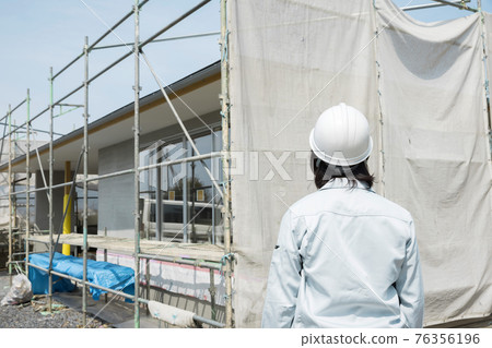 Female worker looking at the construction site 76356196